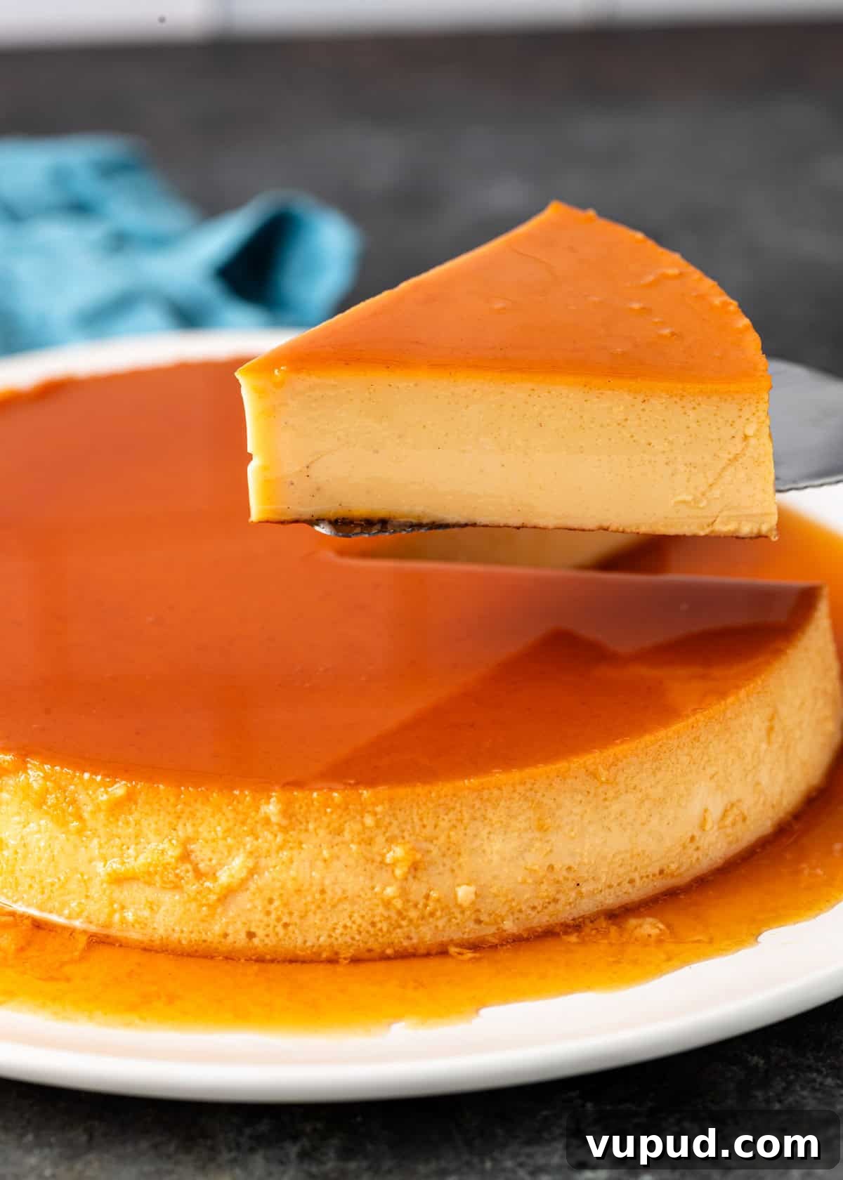 side view: a spatula lifting up a piece of flan