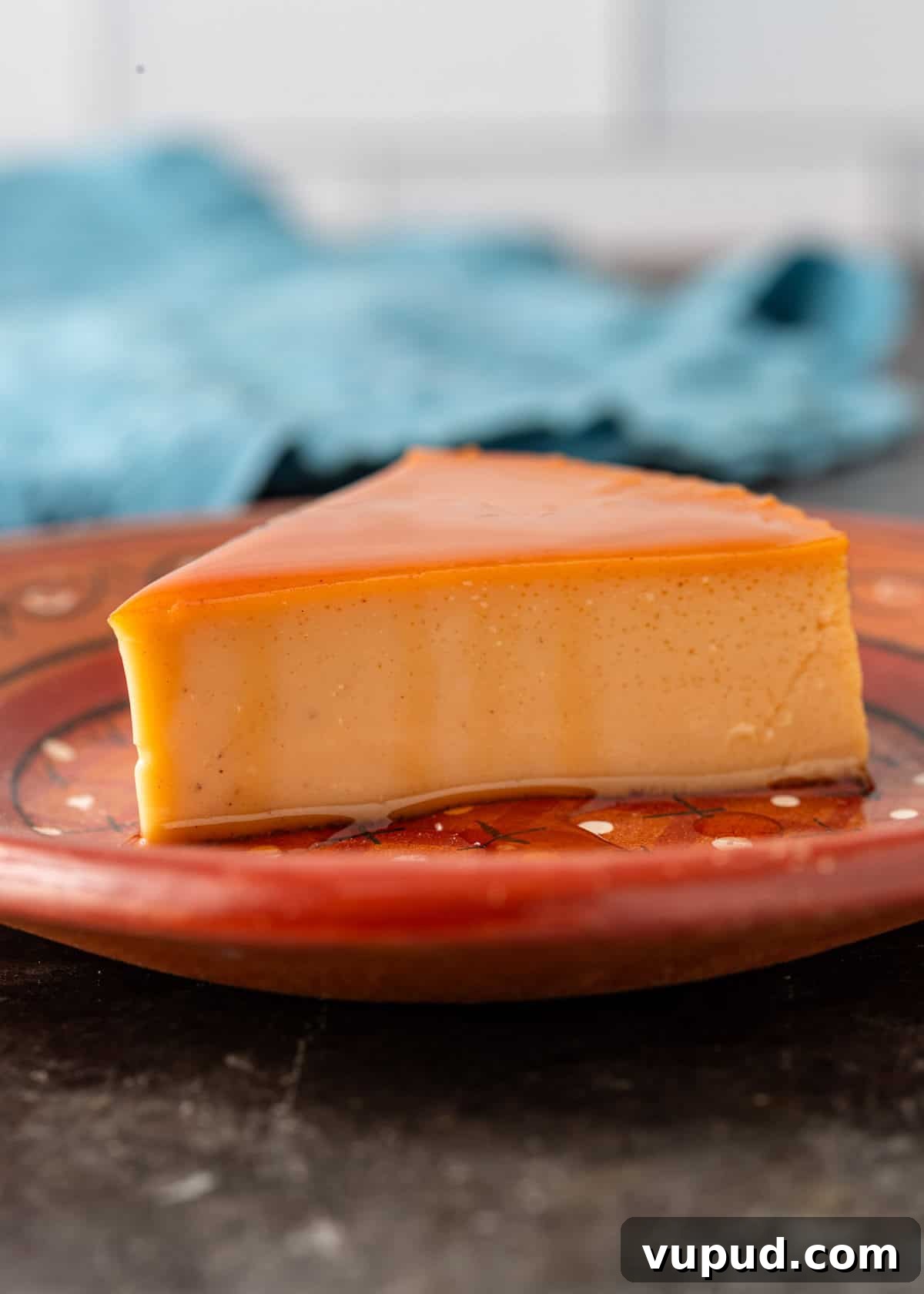 side view: a slice of my flan recipe on a ceramic plate