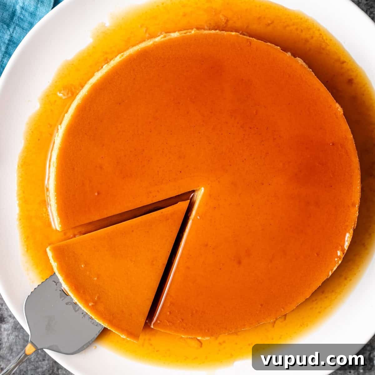 overhead: a spatula removing a slice of my Mexican flan recipe