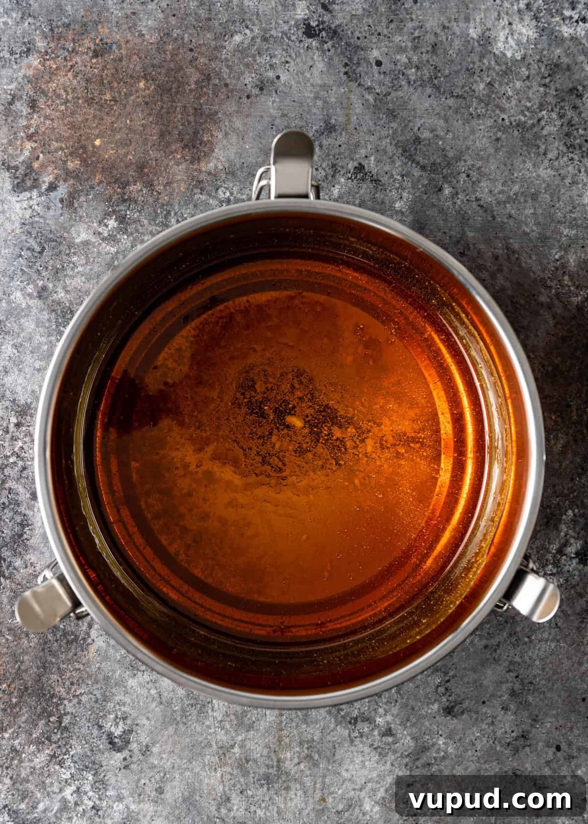overhead process shot: pouring the caramel to the bottom of the flan pan