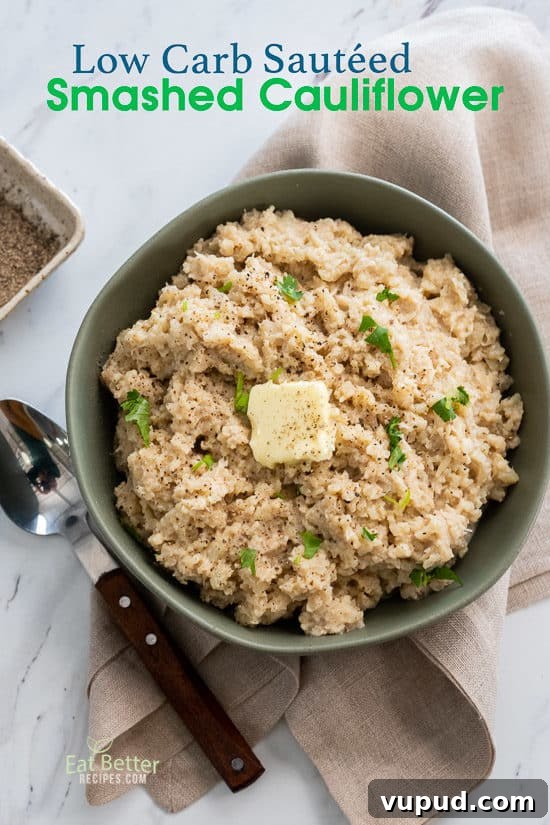 Low Carb Smashed Cauliflower Recipe KETO Cauliflower @EatBetterRecipes keto Smashed Cauliflower Recipe in a bowl with spoon