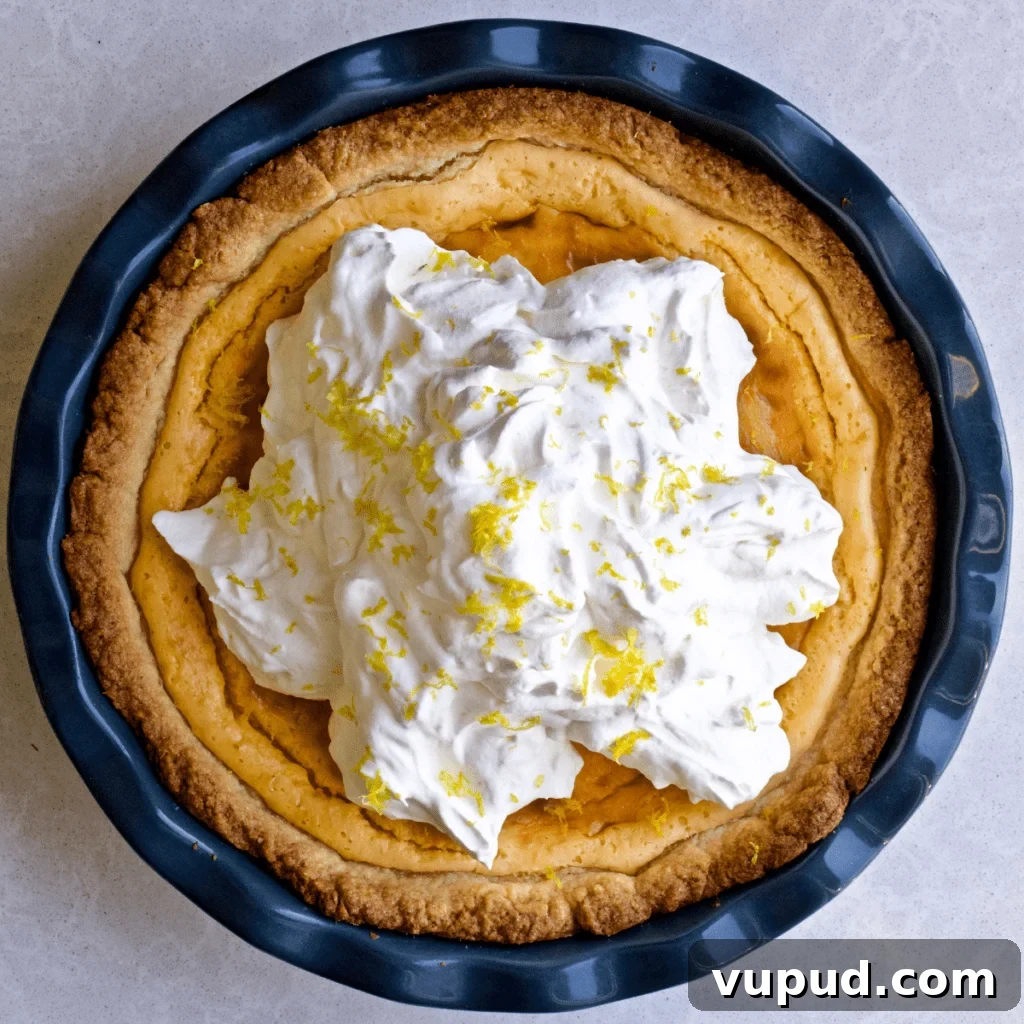 Authentic Italian Ricotta Pie Recipe: Classic Sicilian Crostata 2 Italian ricotta pie in a dark blue dish with whipped cream on top.