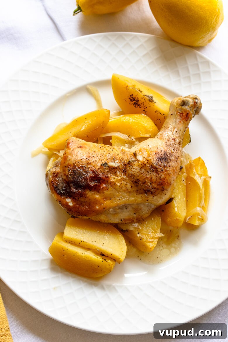 Authentic Greek Lemon Chicken Recipe with Crispy Roast Potatoes 11 Lemon chicken ready to be enjoyed served on a white lettice plate.