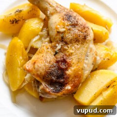Authentic Greek Lemon Chicken Recipe with Crispy Roast Potatoes 12 Greek lemon chicken and potatoes served on a cream white plate.