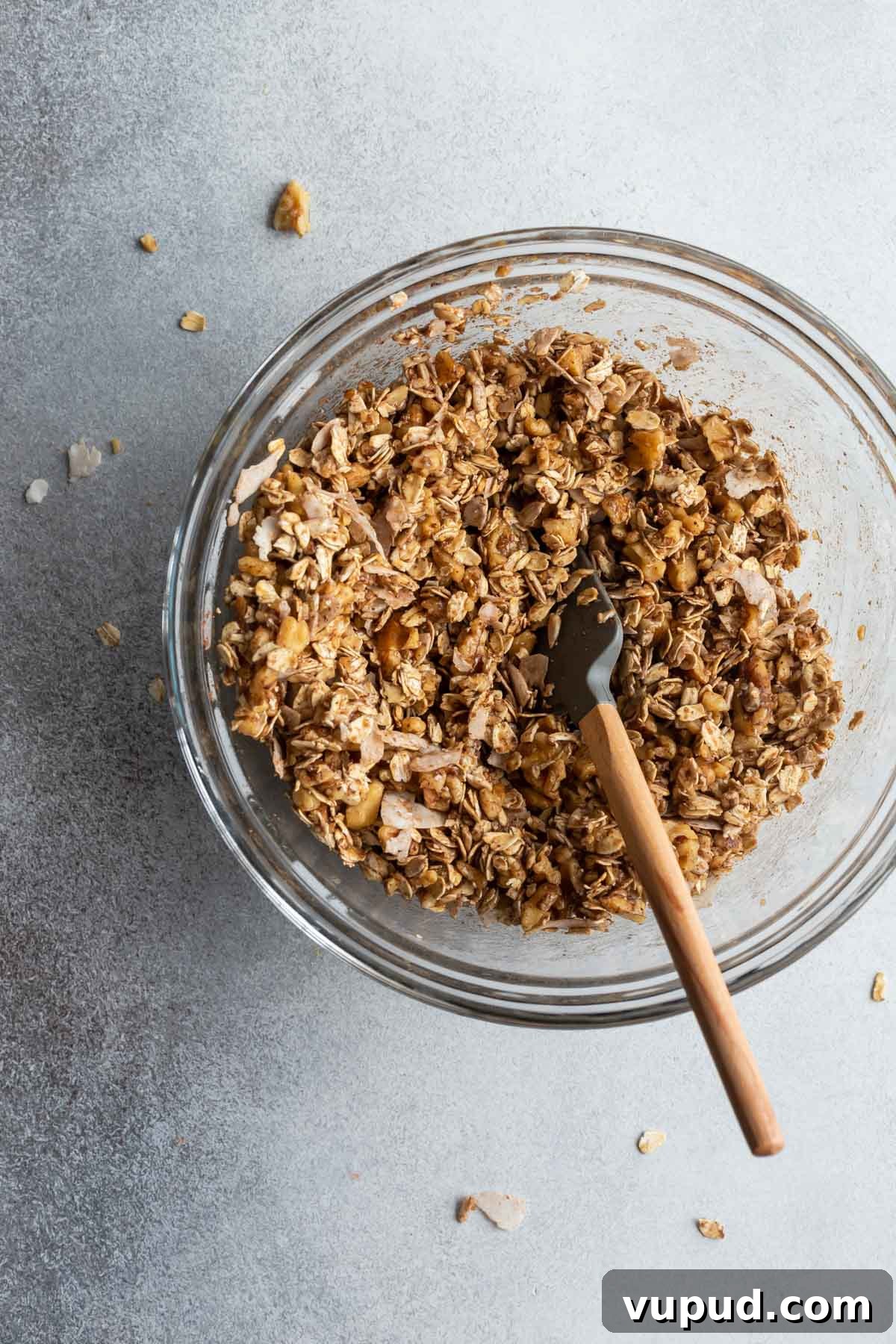 Maple Walnut Granola Recipe: Crunchy Homemade Clusters 4 Ingredients for maple granola being mixed together in a glass bowl.