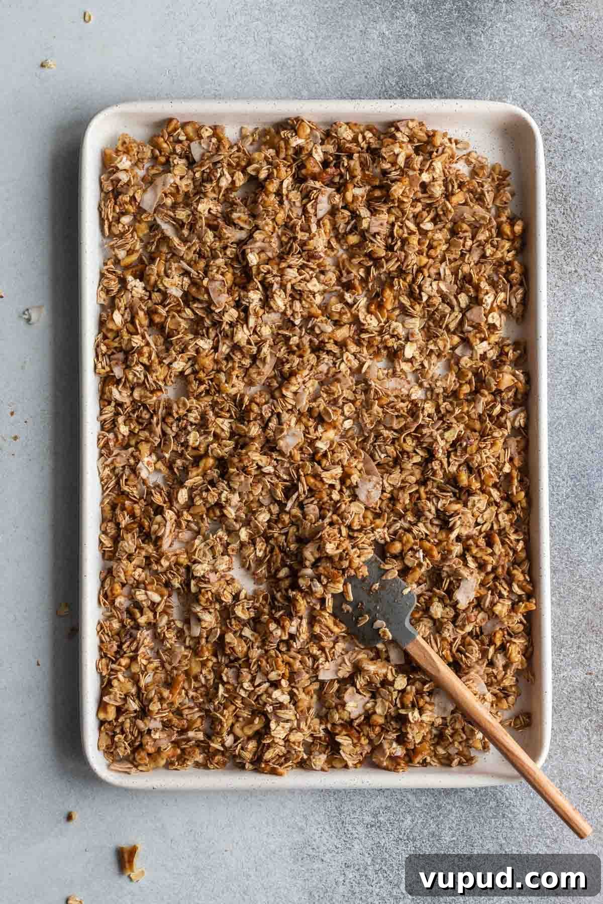 Maple Walnut Granola Recipe: Crunchy Homemade Clusters 5 Maple walnut granola spread out on a baking sheet and ready for the oven.