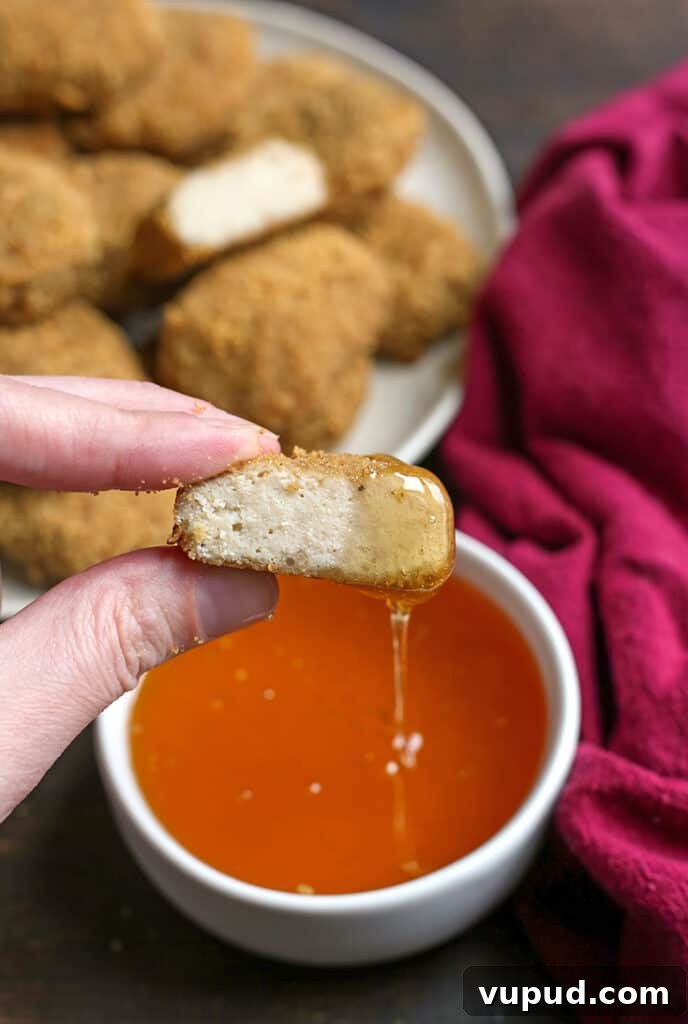 Crispy Gluten-Free Chicken Nuggets Recipe for Kids and Adults 4 a paleo chicken nugget cut in half dup in a bowl oh honey