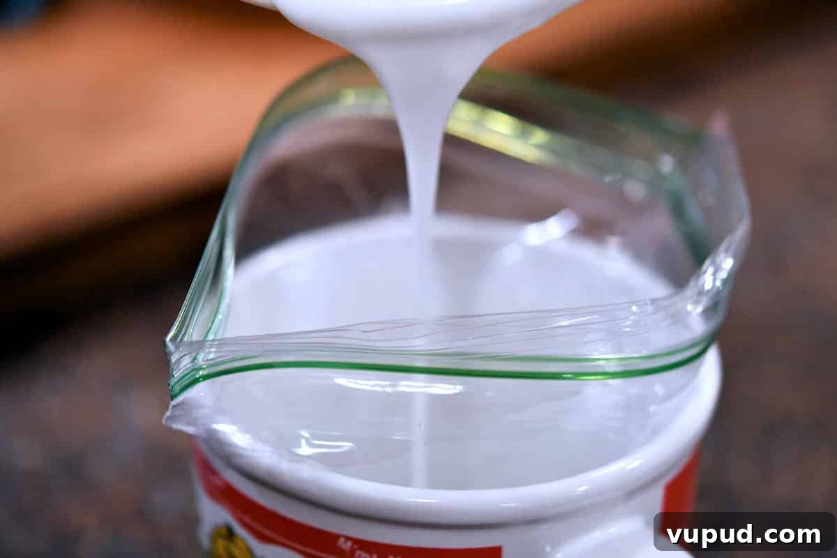 Buttermilk Bisquick Blueberry Biscuits Recipe for Flaky Results 11 pouring powdered sugar glaze into a ziploc bag