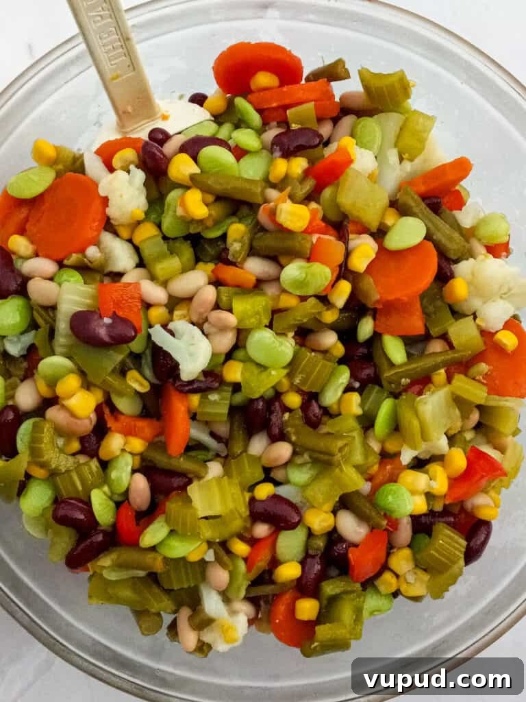 vegetables and beans mixed in a large bowl