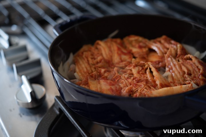 Tomato Kimchi Stew Recipe: Savory Korean Tomato-Kimchi Jjigae 5 Sliced kimchi in a pot.