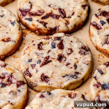 An array of baked slice and bake cookies on a pan.