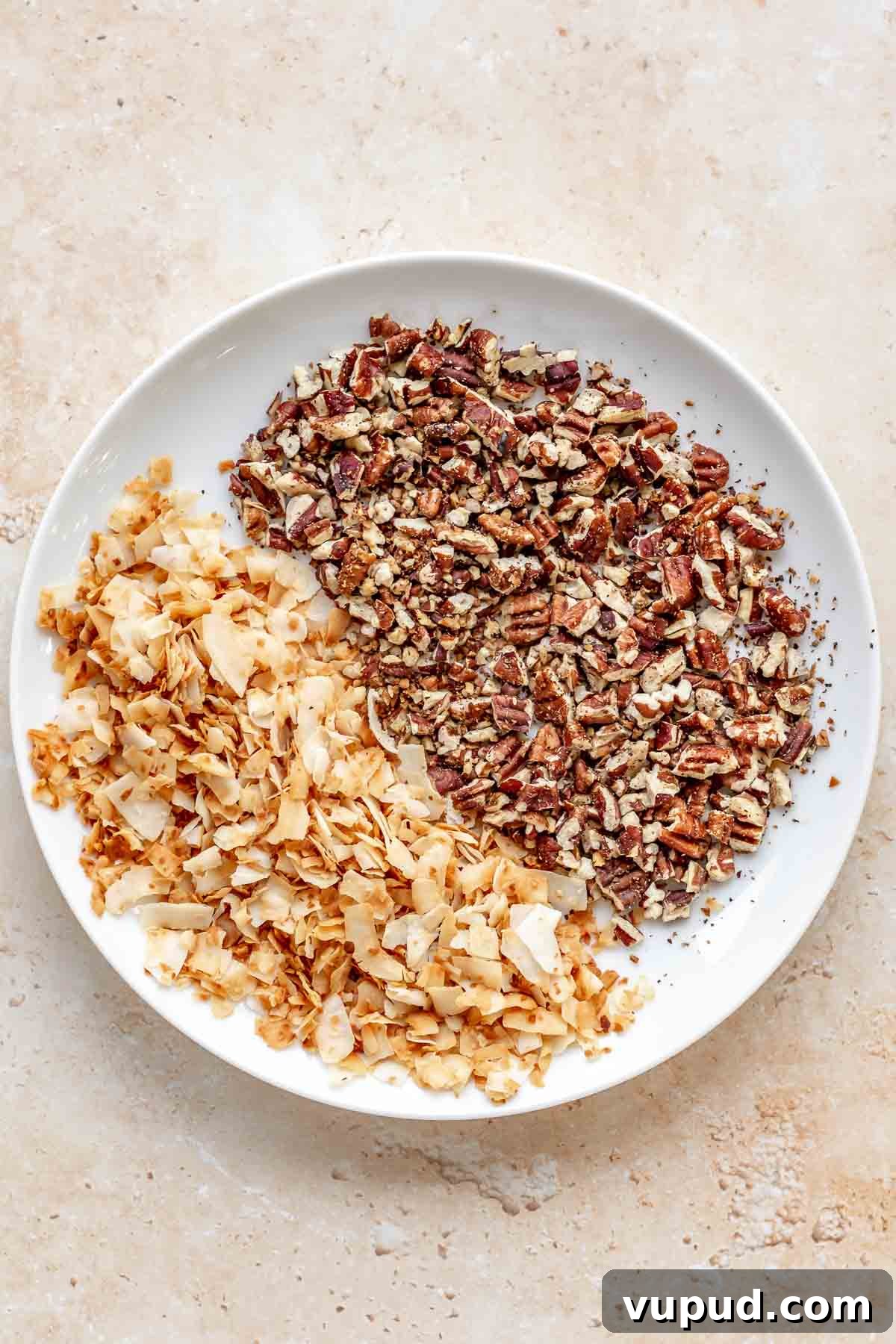 Chewy Coconut Pecan Cookies Recipe for Crispy Edges and Gooey Center 5 Toasted pecans and coconut in a bowl.