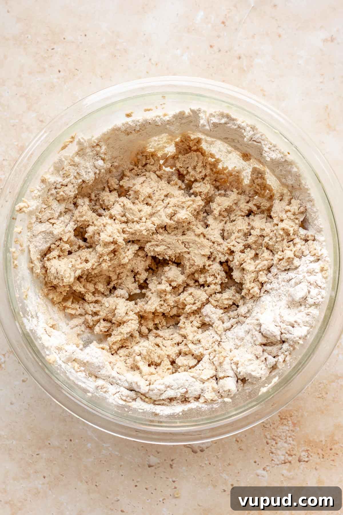 Chewy Coconut Pecan Cookies Recipe for Crispy Edges and Gooey Center 8 Flour halfway mixed in to cookie dough in a bowl.