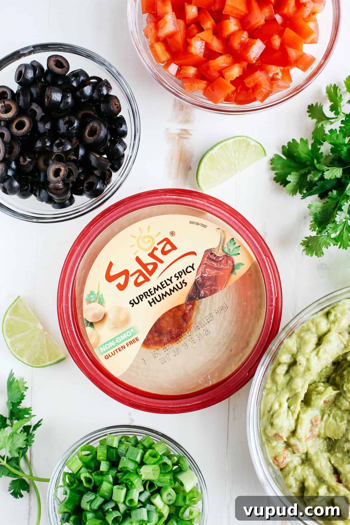 Spicy 7-Layer Taco Dip Recipe — Flavorful Fiesta Appetizer 3 Healthier 7 Layer Spicy Taco Dip made with Greek yogurt, hummus, fresh guacamole, chunky salsa, homemade taco seasoning and all the fun toppings!