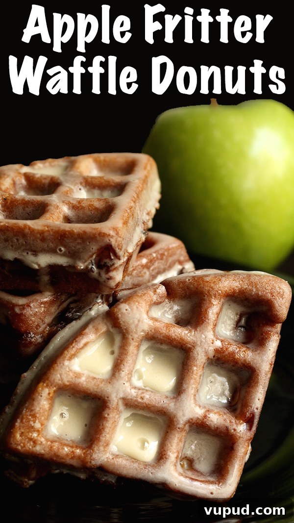 Apple Fritter Waffle Donuts Recipe: Crisp, Cinnamon-Glazed Treats 3 Apple Fritter Waffle Donuts stacked up on top of each other. A green apple is out of focus in the background.