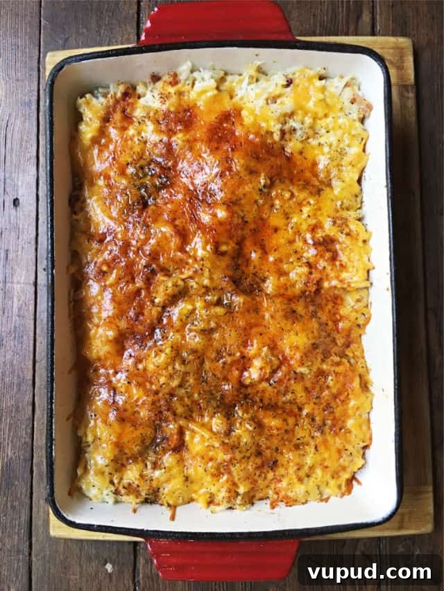 Cheesy Hashbrown Casserole with Crispy Bacon Topping 4 a baked cheesy top of hashbrown casserole in red dish