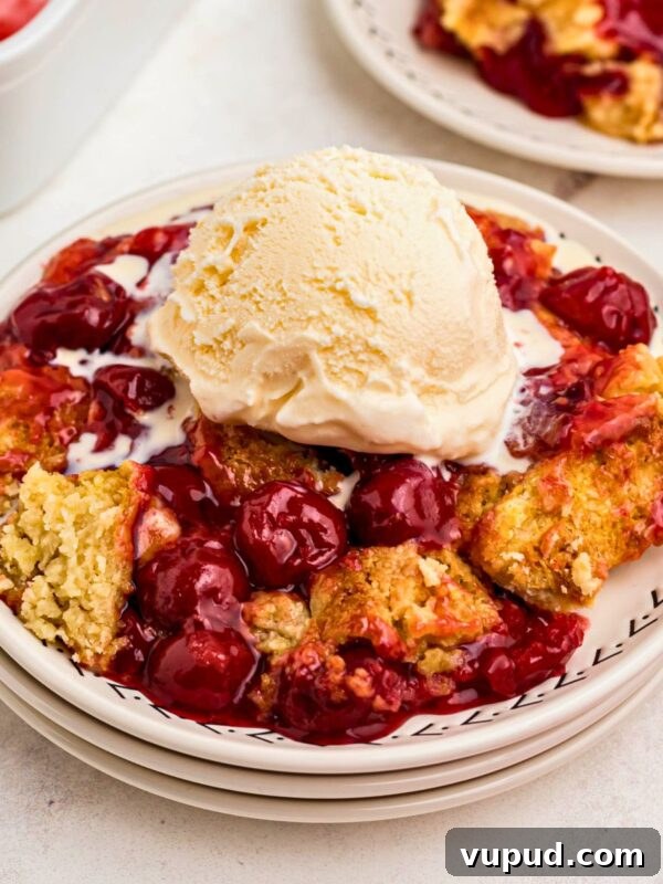 Oreo Popcorn Recipe: Creamy Chocolate Cookie Popcorn Treat 10 Golden crusted cherry dump cake on white plates topped with vanilla ice cream.