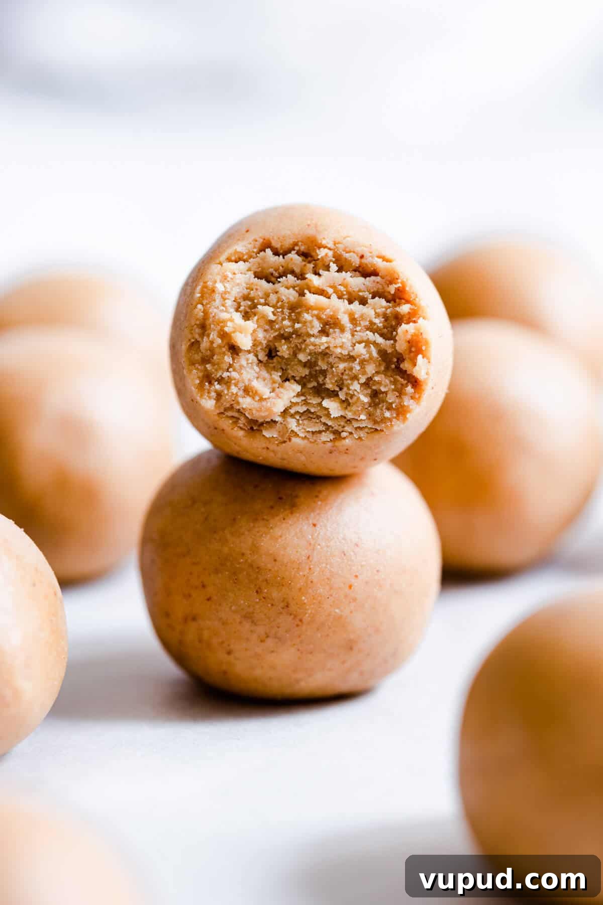 Peanut Butter Energy Balls: 3-Ingredient No-Bake Snack 2 side close up of two energy balls stacked on top of eachother
