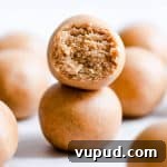 Peanut Butter Energy Balls: 3-Ingredient No-Bake Snack 9 side close up of two energy balls stacked on top of eachother