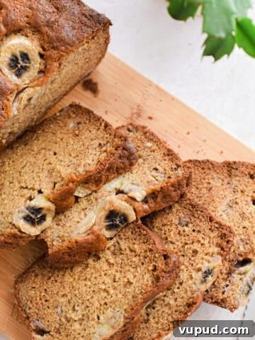 The banana bread with Greek yogurt is cut into 5 pieces on a cutting board.