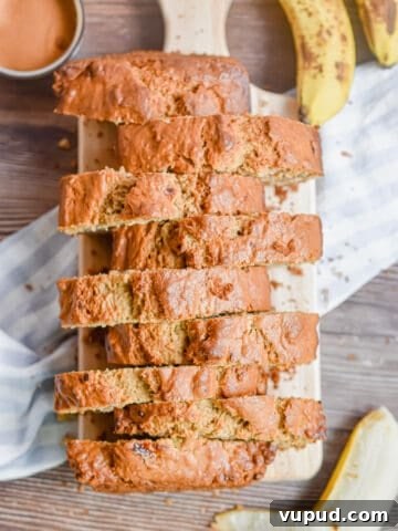 The banana bread without butter is on a cutting board and cutting into pieces.