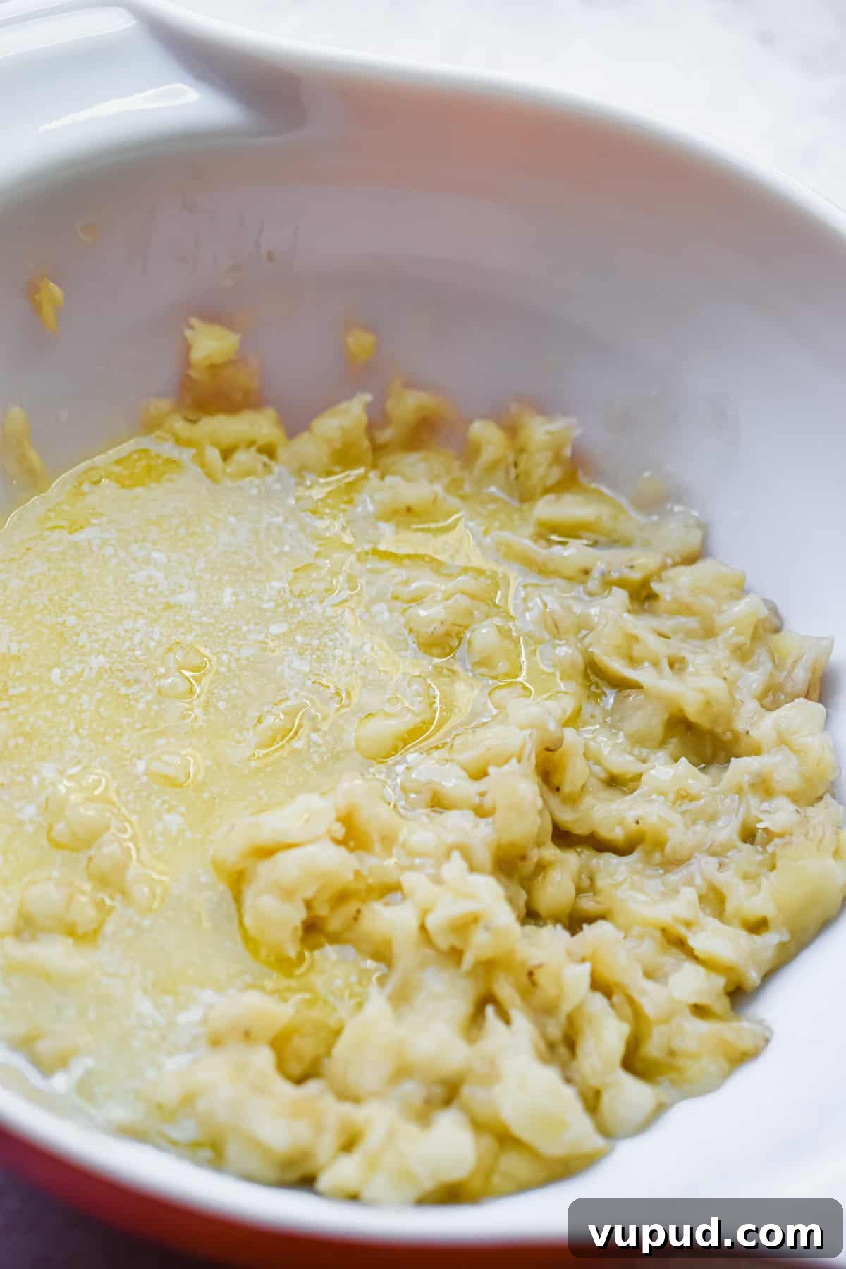 4-Ingredient Banana Bread from Cake Mix — Quick Recipe 5 The butter and eggs are added to the mashed bananas.