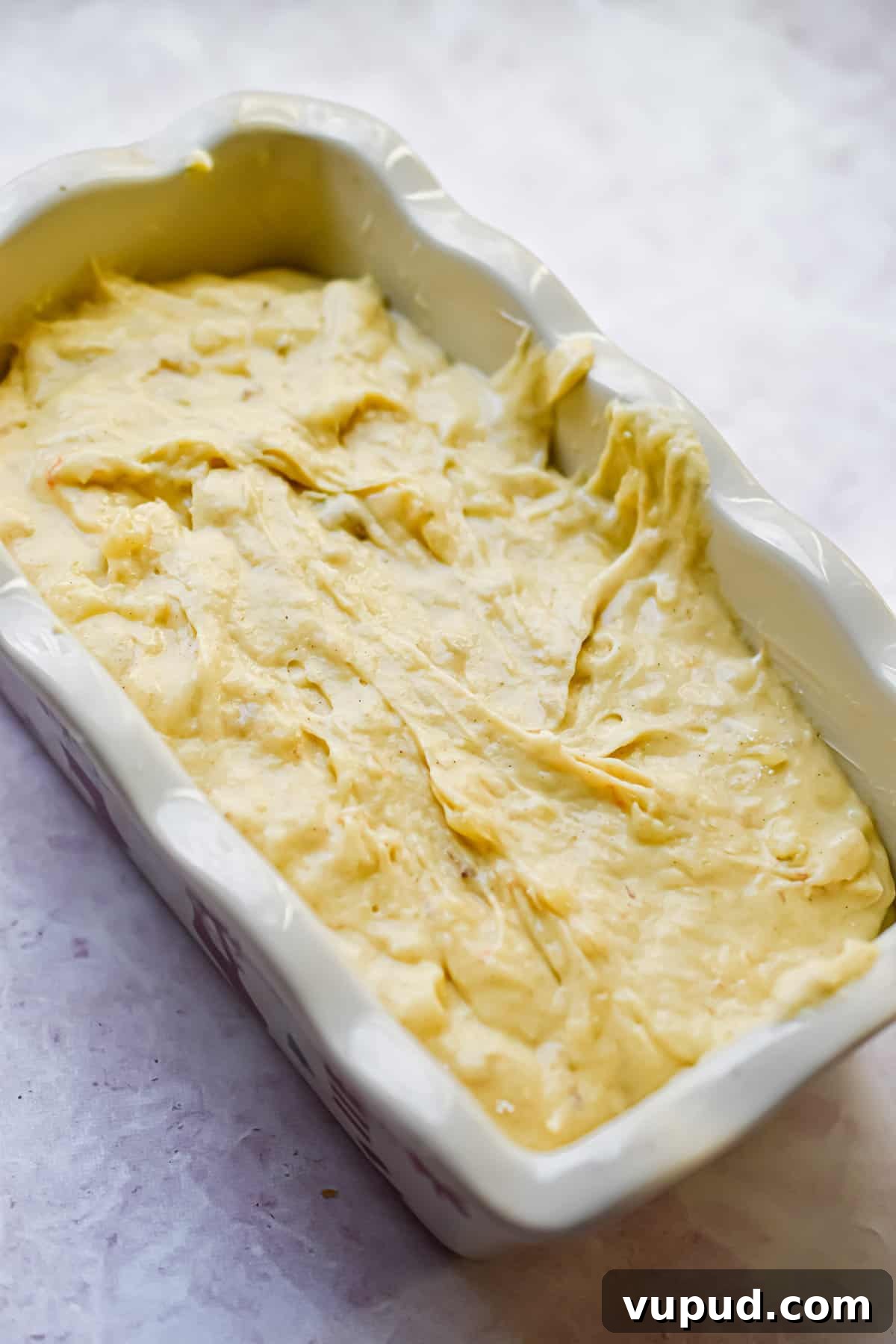 4-Ingredient Banana Bread from Cake Mix — Quick Recipe 8 The batter is added to a greased loaf pan.