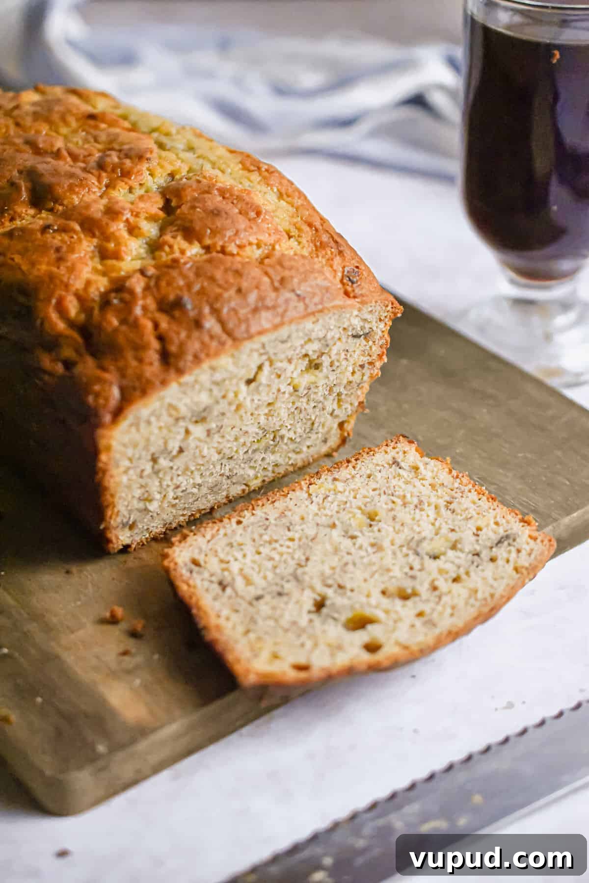 4-Ingredient Banana Bread from Cake Mix — Quick Recipe 9 A side shot of a cut piece of cake mix banana bread.