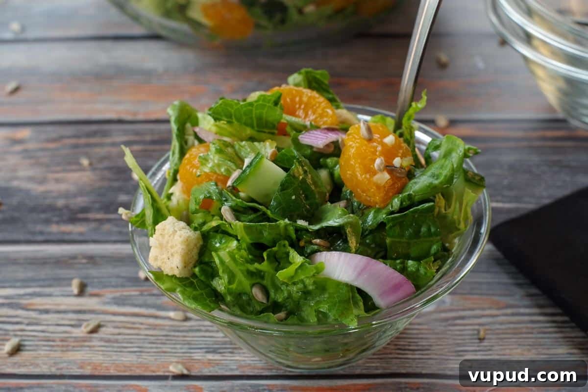 Zesty Mandarin Orange Salad Recipe with Citrus Vinaigrette 10 Mandarin Orange salad in a small glass bowl with a fork