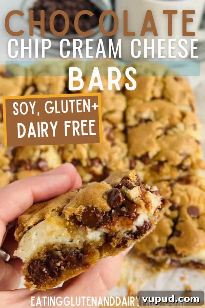Chewy Chocolate Chip Cream Cheese Bars Recipe 3 A hand is holding a chocolate chip cream cheese bar.