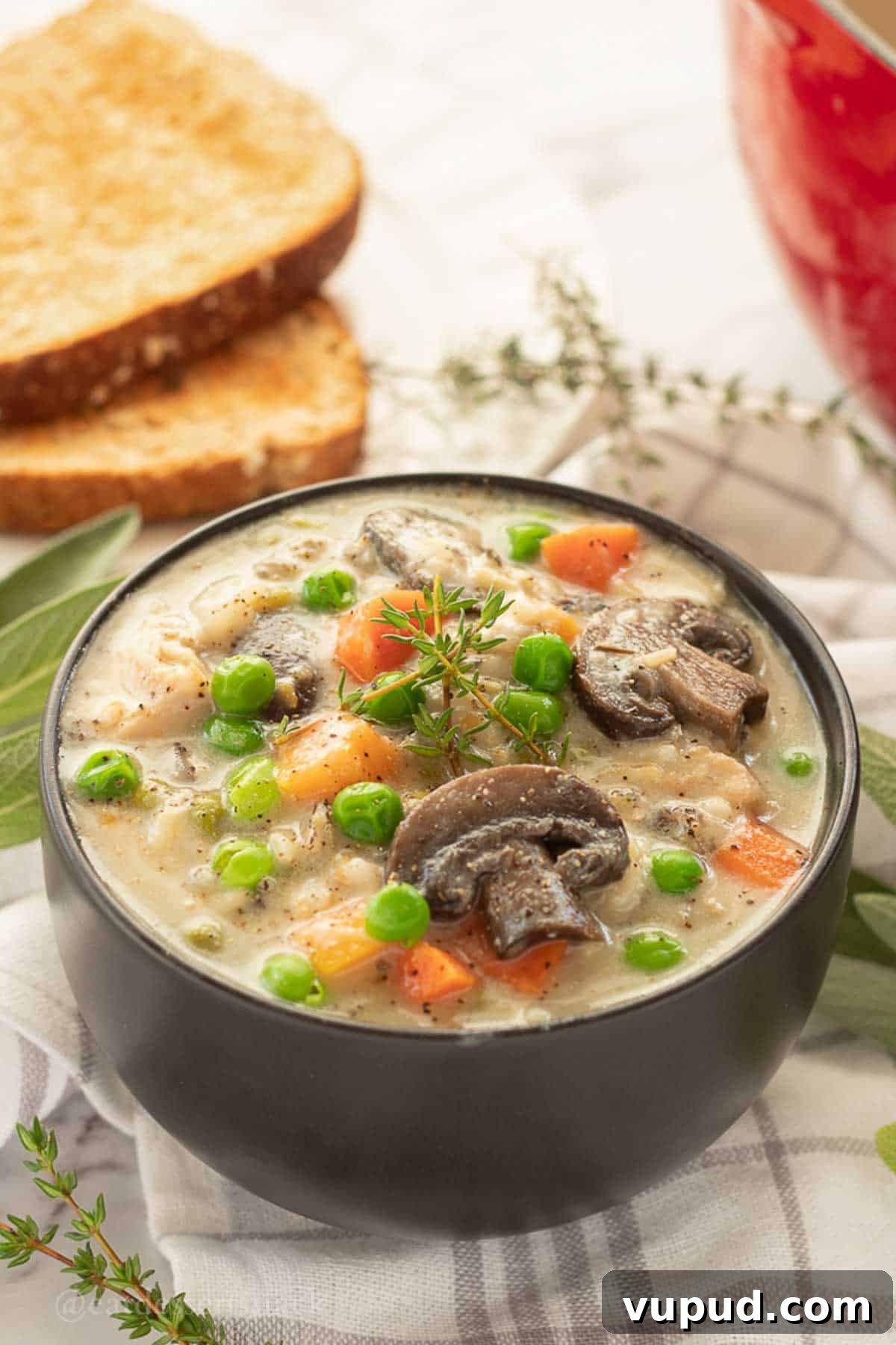 Creamy Chicken and Wild Rice Soup Recipe for Cozy Comfort 2 Bowl of creamy chicken wild rice soup with herbs.