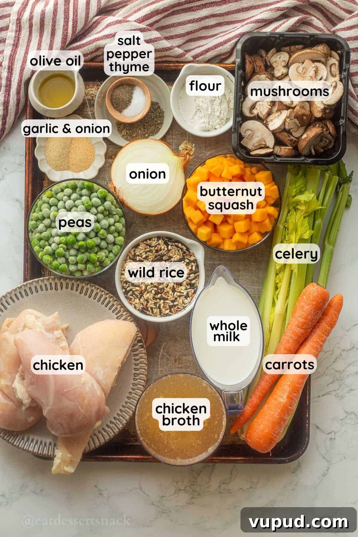 Creamy Chicken and Wild Rice Soup Recipe for Cozy Comfort 3 Labeled ingredients for creamy chicken and wild rice soup in bowls on metal pan.