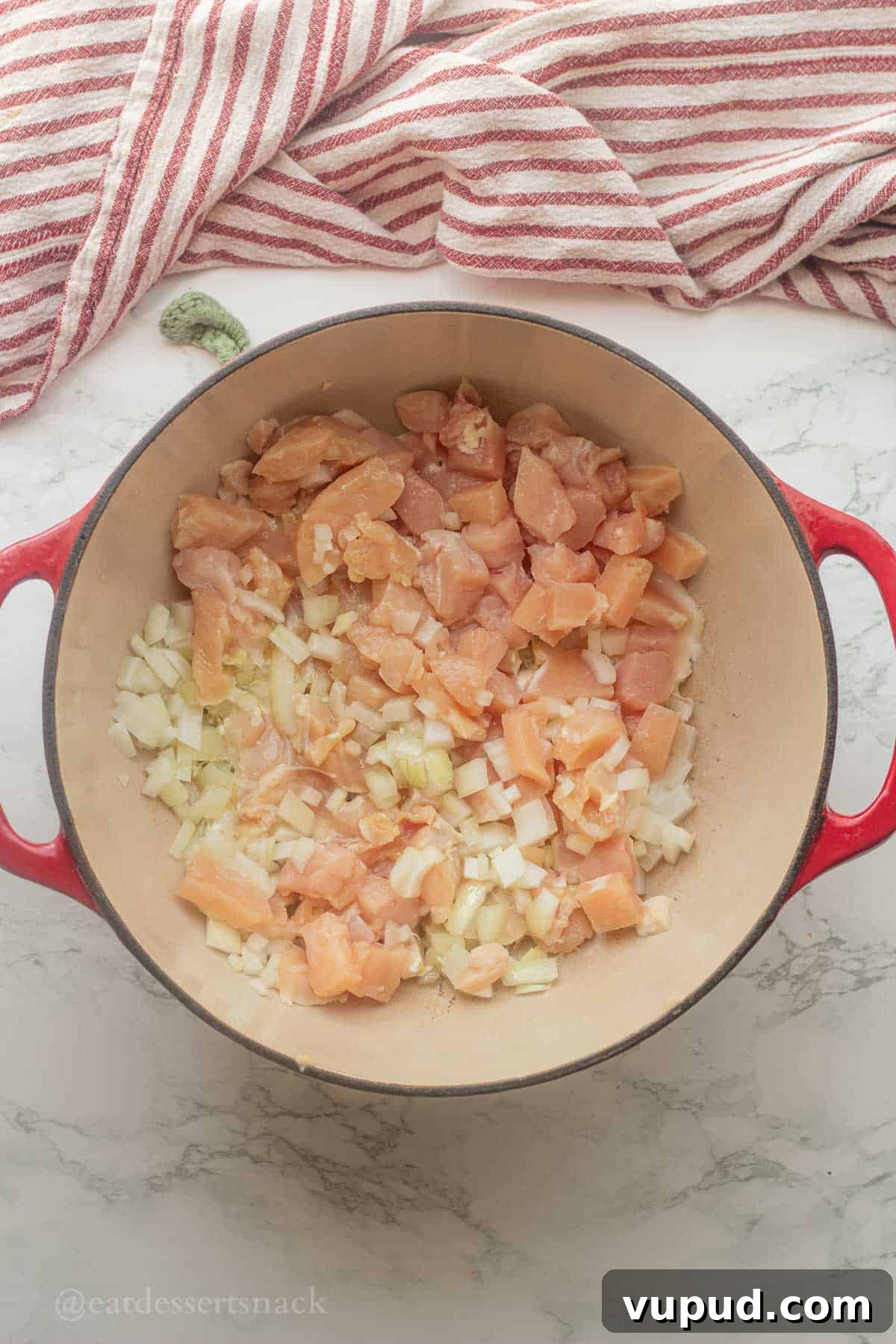 Creamy Chicken and Wild Rice Soup Recipe for Cozy Comfort 4 Raw chicken and onions in pot with olive oil.