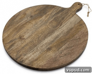 Top Kitchen Gifts for Home Cooks and Food Lovers 33 Front view of a large round wood serving board