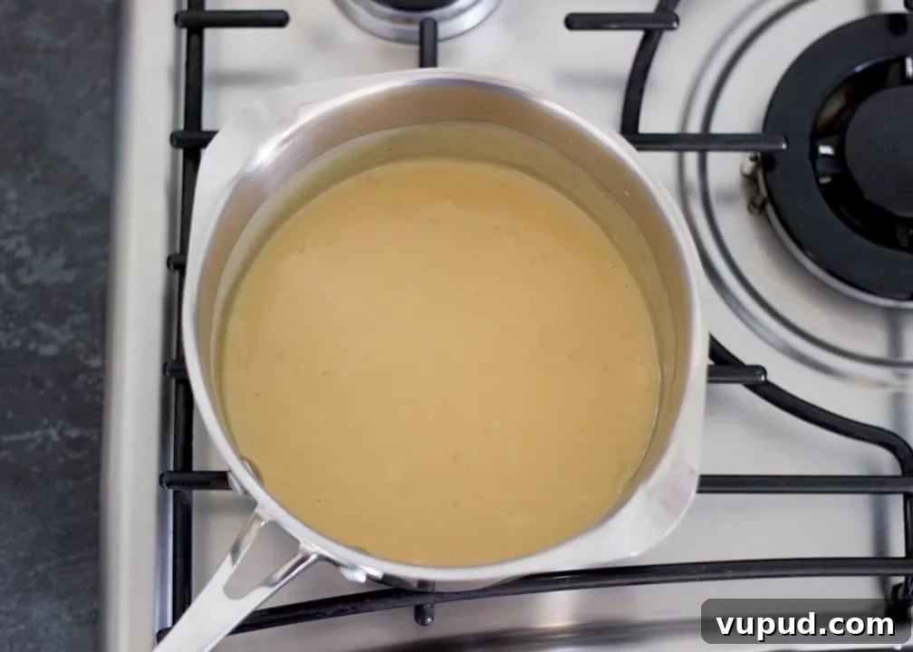 Chocolate Orange Caramel Shortbread Recipe — Zesty Caramel Slice 11 Cooked caramel in a saucepan on the hob
