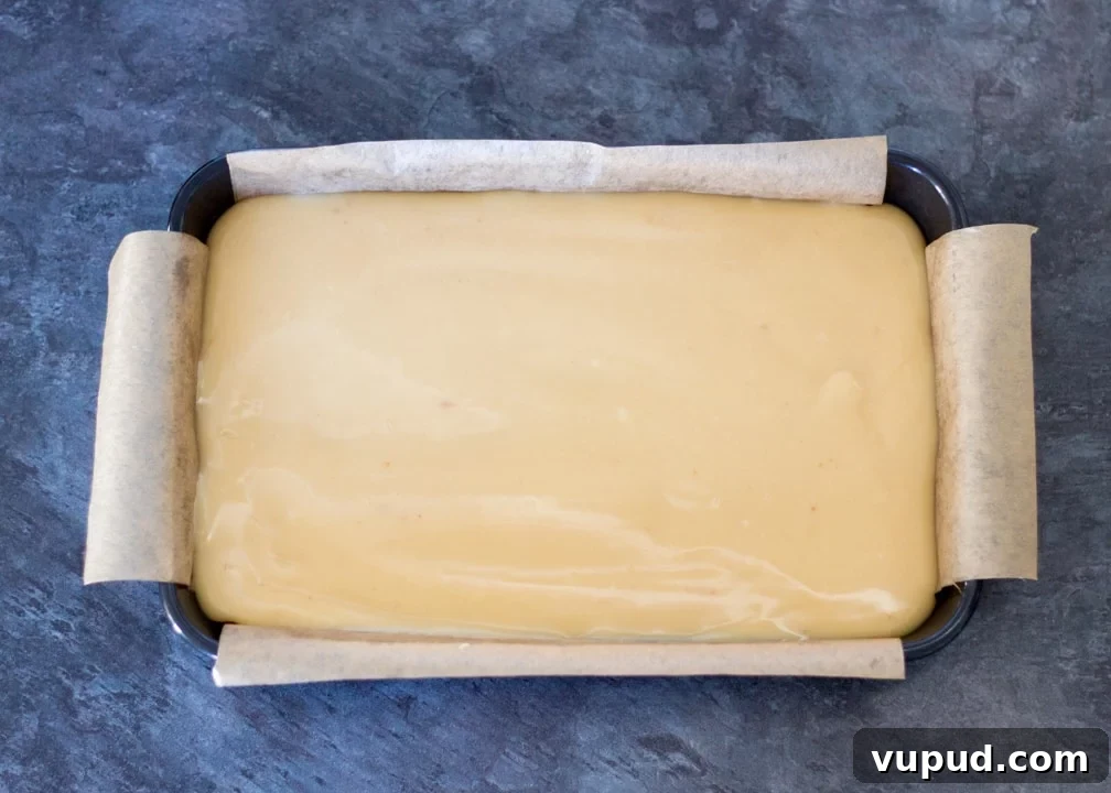 Chocolate Orange Caramel Shortbread Recipe — Zesty Caramel Slice 12 Caramel poured on top of the biscuit layer in a baking tin