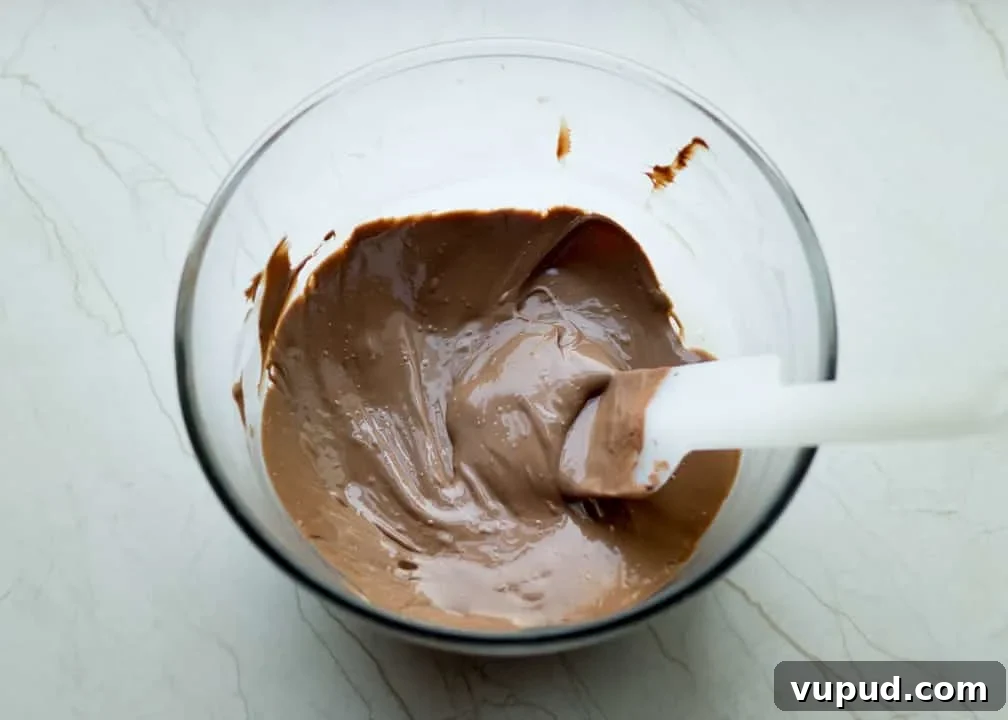Chocolate Orange Caramel Shortbread Recipe — Zesty Caramel Slice 13 Melted chocolate in a bowl
