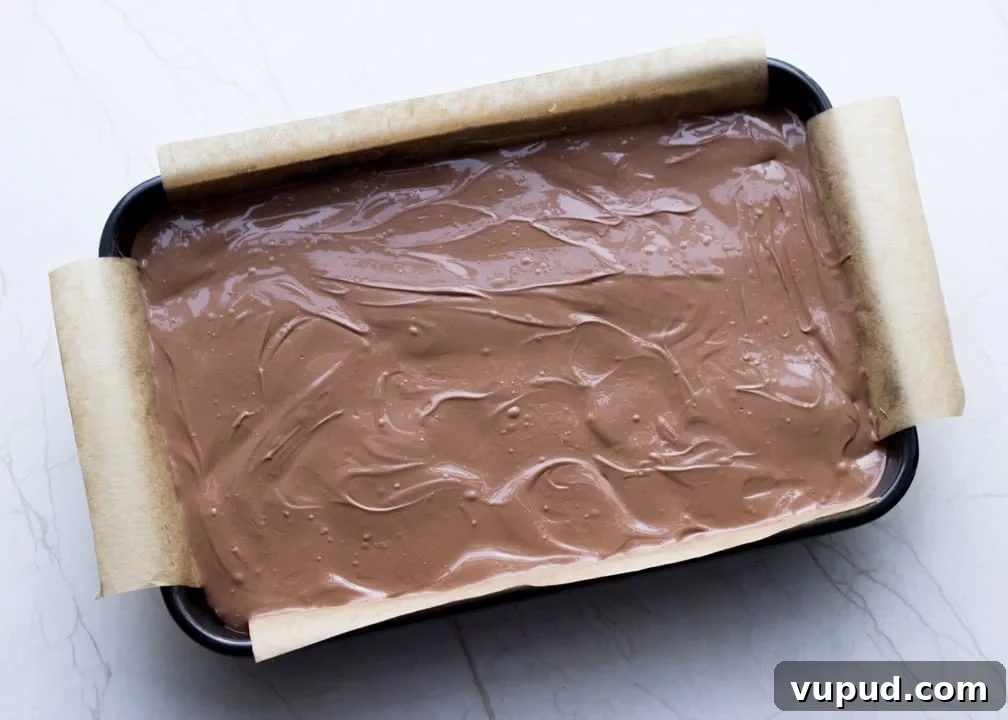 Chocolate Orange Caramel Shortbread Recipe — Zesty Caramel Slice 14 Melted chocolate smoothed over the caramel layer in the baking tray