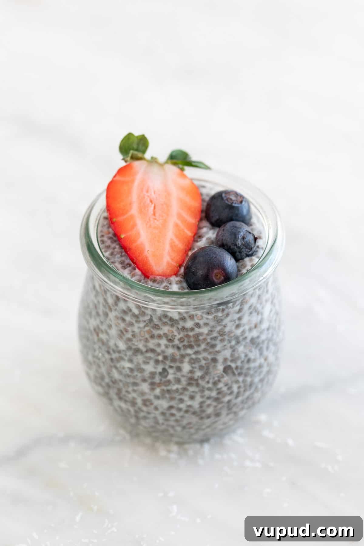 4-Ingredient Chia Pudding Recipe: Creamy, Quick Breakfast 2 A jar with chia pudding and topped with berries.