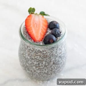 4-Ingredient Chia Pudding Recipe: Creamy, Quick Breakfast 13 A jar with chia pudding and topped with berries.