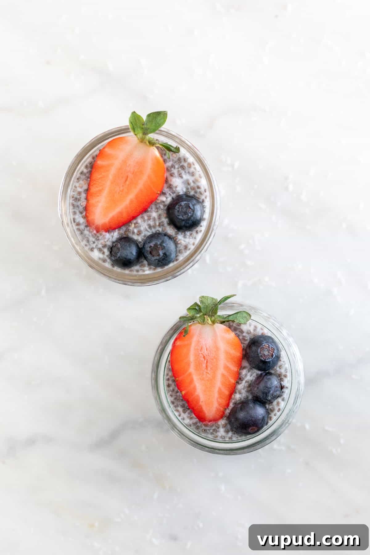 4-Ingredient Chia Pudding Recipe: Creamy, Quick Breakfast 7 Overview of two jars with chia pudding and topped with berries.