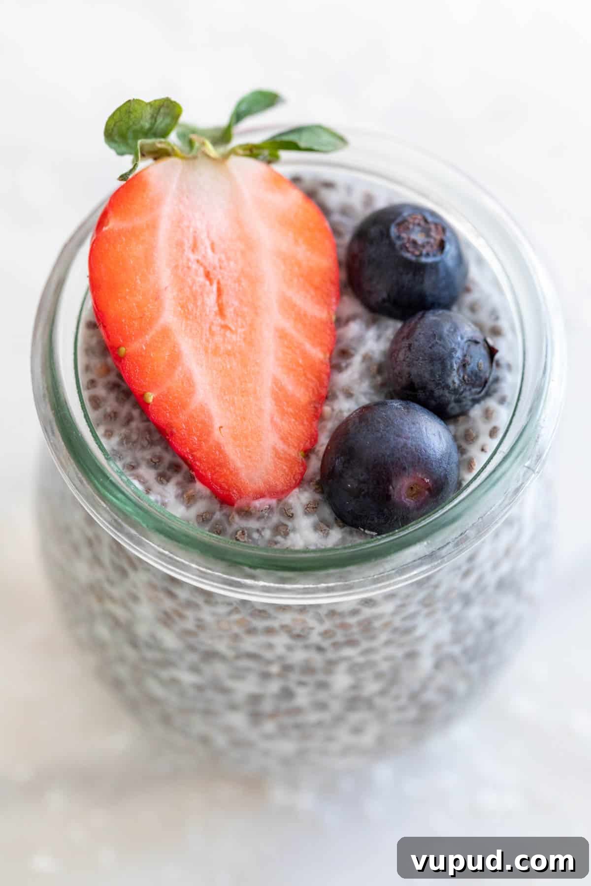 4-Ingredient Chia Pudding Recipe: Creamy, Quick Breakfast 8 A jar of chia pudding with some berries on top.