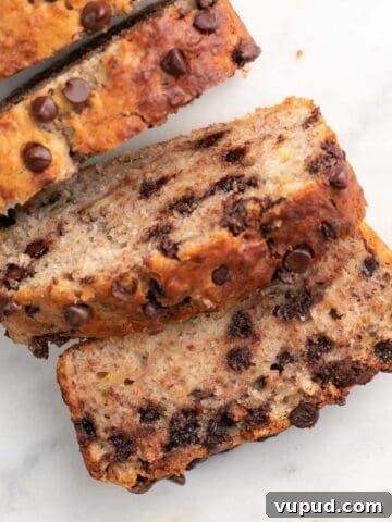 Sliced vegan banana bread on marble.