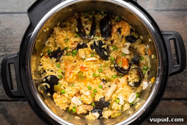 Ultimate Instant Pot Paella: Quick Spanish Rice & Seafood Recipe 10 Overhead view of paella ingredients in an Instant Pot.
