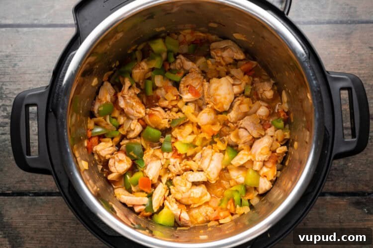 Ultimate Instant Pot Paella: Quick Spanish Rice & Seafood Recipe 7 Overhead view of paella ingredients in an Instant Pot.