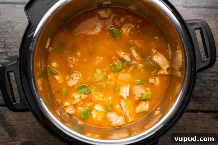 Ultimate Instant Pot Paella: Quick Spanish Rice & Seafood Recipe 8 Overhead view of paella ingredients in an Instant Pot.