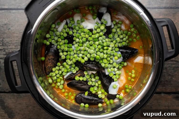 Ultimate Instant Pot Paella: Quick Spanish Rice & Seafood Recipe 9 Overhead view of paella ingredients in an Instant Pot.