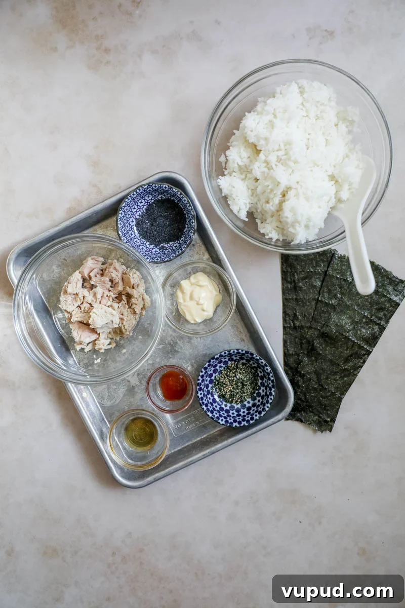 Spicy Tuna Onigiri Recipe — Authentic Japanese Rice Balls 3 Ingredients to make spicy tuna Onigiri on a sheet pan.