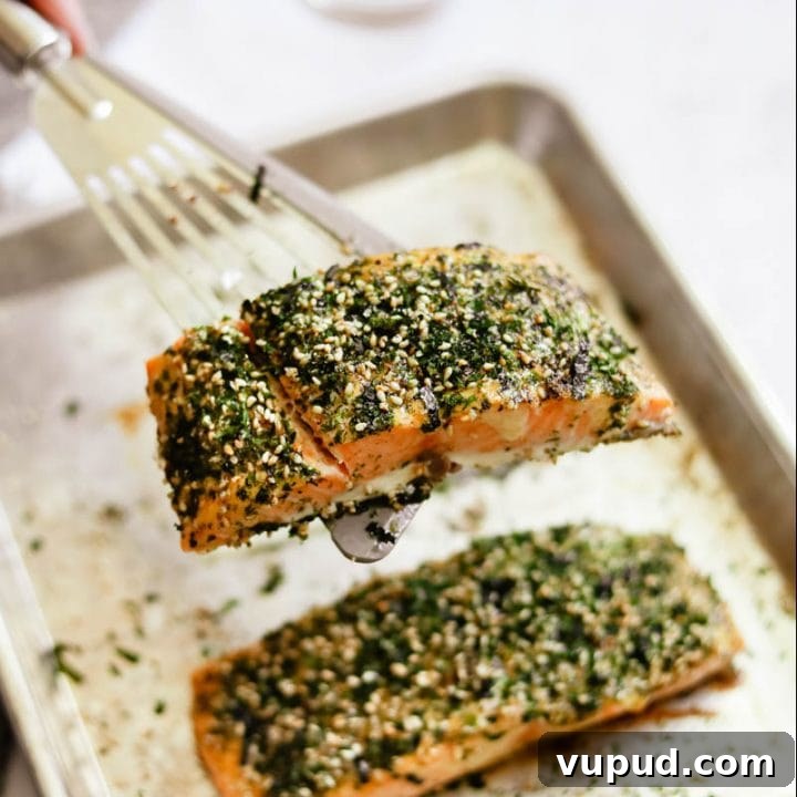 Furikake Salmon with Kewpie mayo on a sheet pan with a spatula.