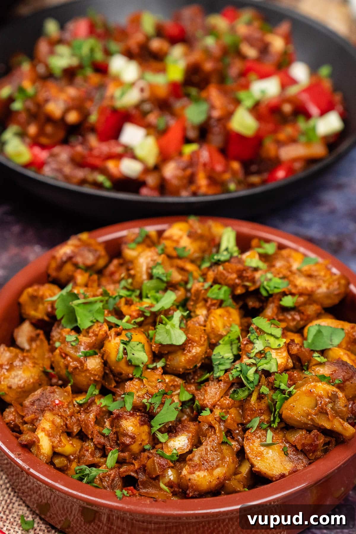 Indian Mushroom Bhaji Recipe: Flavorful Mushroom Curry Guide 2 Mushroom Bhaji Indian Curry in a tapas dish with fresh coriander on top and chilli paneer in the background